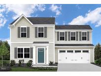 Charming two-story home featuring a two-car garage, neutral siding, and complemented by dark shutters at 1537 Ivy Meadow Ln, Zebulon, NC 27597