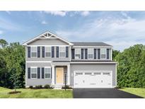 Charming two-story home with gray siding, black shutters, yellow door, and two-car garage at 1541 Ivy Meadow Ln, Zebulon, NC 27597