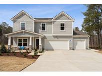 Charming two-story home featuring a spacious two-car garage and a welcoming front porch with stone accents at 27 Cribbs Ln, Middlesex, NC 27557