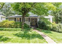 Charming single-story home with a beautiful lawn and lush landscaping at 2913 Anderson Dr, Raleigh, NC 27608