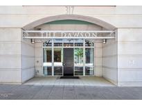Welcoming entrance to The Dawson with a black door, large windows, and stone facade at 317 W Morgan St # 320, Raleigh, NC 27601