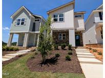 Charming new construction with inviting brick and siding exterior and newly installed front yard landscaping at 330 Cottage Hill Way, Knightdale, NC 27604