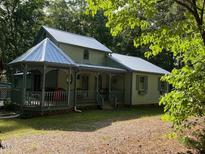 Charming home featuring a gazebo, covered porch and metal roof at 358 Pool Rock Shores Ln, Henderson, NC 27537