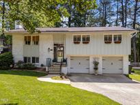 Charming two-story home with brick accents, attached garage, and well-maintained lawn at 3620 Arrowwood Dr, Raleigh, NC 27604