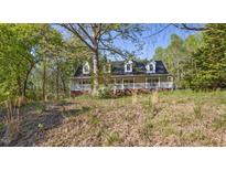 Charming two-story home with inviting front porch and lush, natural landscaping at 5019 Dorsey Rd, Oxford, NC 27565