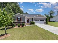 Charming single-story home with a well-manicured lawn, attached garage, and inviting curb appeal at 59 White Quartz Pl, Fuquay Varina, NC 27526