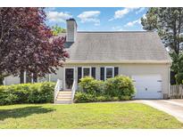 Charming single-story home with manicured lawn, trimmed bushes, and a one-car garage at 809 Maple Shade Ln, Apex, NC 27502