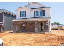 New two-story home featuring a brick foundation and white siding awaiting its landscaping and final touches at 817 Ottawa Dr, Garner, NC 27529