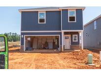 New two-story home featuring blue siding, unfinished yard, and an attached garage at 825 Ottawa Dr, Garner, NC 27529