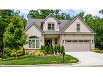 Charming home with a manicured lawn, two-car garage and craftsman curb appeal at 98102 Drummond, Chapel Hill, NC 27517