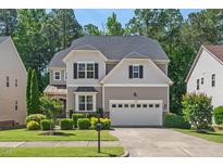 Beautiful two-story home featuring a well-manicured lawn and a two-car garage with a driveway at 1008 Justice Walk Ave, Morrisville, NC 27560