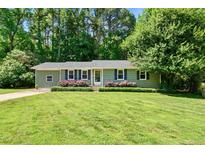 Charming one-story home with a well-maintained lawn and lush landscaping at 105 Choyce Ct, Garner, NC 27529
