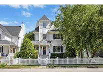 Charming two-story home featuring a beautiful white picket fence and well-manicured landscaping at 111 Chancellors Ridge Dr, Durham, NC 27713