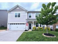 Charming two-story home with a well-manicured lawn and inviting front porch at 1254 Salters St, Burlington, NC 27215