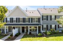 Charming townhouse featuring gray siding, black shutters, and a well-manicured front yard at 1313 Legacy Greene Ave, Wake Forest, NC 27587