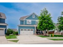 Charming blue two-story home with a well-manicured lawn, and a two car garage at 2020 Cotton Barn Ct, Wendell, NC 27591