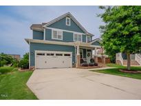 Beautiful two-story home featuring a two-car garage, brick-accented porch, and well-manicured lawn at 2020 Cotton Barn Ct, Wendell, NC 27591
