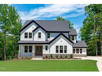 Stunning two-story home with white siding, a gray roof, manicured lawn, and beautiful curb appeal at 248 Ashford Dr, Pittsboro, NC 27312