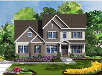 Charming new construction home with stone accents, a covered porch and a meticulously landscaped yard at 253 Inspiration Way, Fuquay Varina, NC 27526