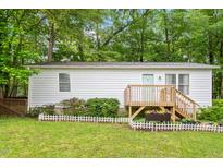 Charming single-story home featuring a wooden deck and well-maintained lawn at 2612 Wade Hampton Rd, Hillsborough, NC 27278