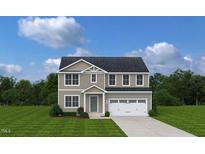 Charming two-story home with a well-maintained lawn and a two-car garage offers an inviting curb appeal at 272 Day Farm Dr, Lillington, NC 27546