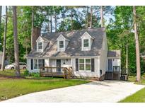 Charming Cape Cod-style home with a well-maintained lawn and inviting front porch, nestled among mature trees at 3 Haggis Ct, Durham, NC 27705