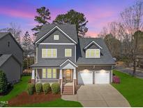 Charming two-story home boasting a manicured lawn, attached garage, and inviting front porch at 300 Redhill Rd, Holly Springs, NC 27540