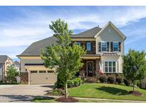 Charming home featuring a landscaped yard, stone accents, and a welcoming front porch with a two-car garage at 3128 Mountain Hill Dr, Wake Forest, NC 27587