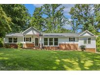 Charming single-story home with brick accents and a well-manicured lawn at 418 S West St, Cary, NC 27511