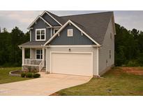 Charming two-story home with a gray and white exterior, attached garage, and well-manicured lawn at 474 Ashpole Trl, Clayton, NC 27520