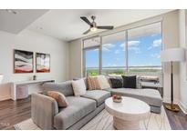 Bright living room with large windows offering scenic views and comfortable seating at 601 W Rosemary St # 715, Chapel Hill, NC 27516