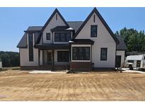 New two-story home showing modern farmhouse design and black trimmed windows at 75 Firefly Ln, Youngsville, NC 27596