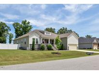 Charming single-story home featuring manicured lawn, inviting front porch and attached garage in a great neighborhood at 7801 Charters End St, Willow Springs, NC 27592