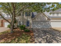 Charming home featuring blue shutters, a well-kept lawn, and an attached two-car garage at 1031 Lake Moraine Pl, Raleigh, NC 27607