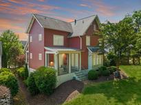 Charming red two-story home with landscaped yard and inviting porch, perfect for outdoor living at 129 Ruskin Dr, Chapel Hill, NC 27516