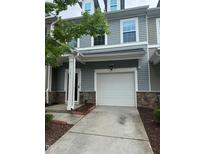 Charming townhome with a one-car garage and well-maintained front yard at 1671 Holly Grove Way, Durham, NC 27713