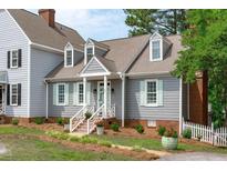 Charming home featuring beautiful gray siding, mint shutters and inviting front porch at 1813 Carrington Dr, Raleigh, NC 27615