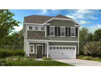 Charming two-story home featuring an attached two car garage and manicured lawn at 198 Blue Butterfly Dr, Angier, NC 27501