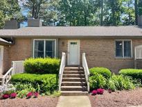 Charming brick home featuring a cozy entrance, well-maintained landscaping, and ample natural light at 200 W Woodcroft Pkwy # 57B, Durham, NC 27713