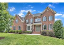 Beautiful red brick two-story home with manicured lawn and mature landscaping at 208 Bridle Boast Rd, Cary, NC 27519