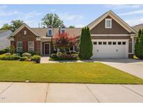 Charming single Gathering home featuring a well-manicured lawn and mature landscaping at 211 Ibis Ln, Durham, NC 27703