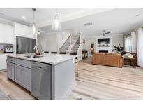Open concept kitchen with stainless steel appliances and an island with barstool seating at 220 Purslane Dr, Franklinton, NC 27525