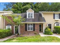 Charming townhome with brick and siding exterior, manicured lawn, and inviting entrance at 2233 Alpine Rd, Durham, NC 27707