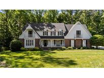 Charming two-story home with a manicured lawn and inviting front porch at 2409 Beechview Ct, Raleigh, NC 27615