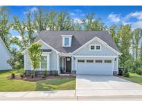 Charming home featuring a two-car garage, well-manicured lawn and lovely curb appeal at 30 Sawtooth Oak Ln, Youngsville, NC 27596