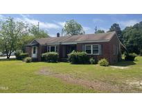 Charming single-story brick home featuring a well-maintained lawn and traditional architectural details at 3301 Amherst Rd, Rocky Mount, NC 27804