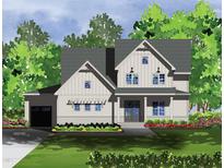 Charming two-story home with white siding, covered entry, attached garage, and a beautifully landscaped front yard at 332 Inspiration Way, Fuquay Varina, NC 27526