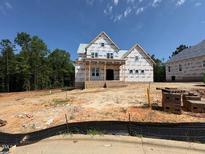Unfinished two-story home showing the exterior with covered front porch and architectural details at 332 Inspiration Way, Fuquay Varina, NC 27526