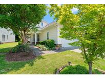 Charming home featuring manicured lawn, mature trees, and inviting covered front porch at 340 Orbison Dr, Cary, NC 27519