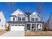 Two-story home with a stone-accented garage, teal front door, and shake siding details at 408 Longleaf Glen Lane, Zebulon, NC 27597